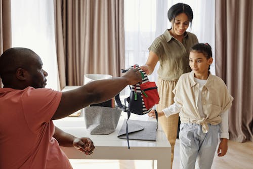 Free Parents Helping their Daughter to get Ready for School Stock Photo