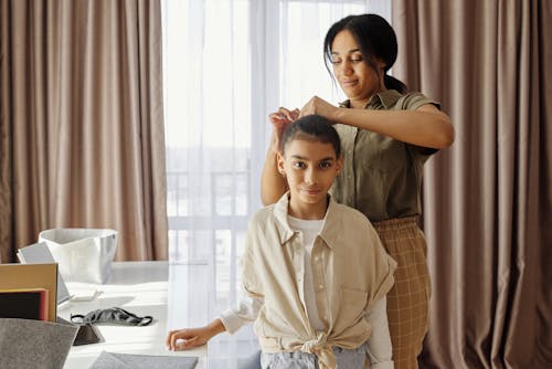 Mother Fixing her Daughters Hair