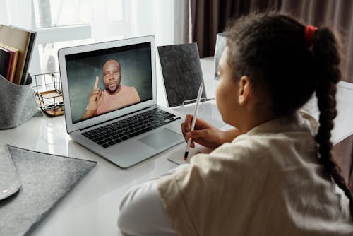 Free Little Girl Taking Classes Online Stock Photo