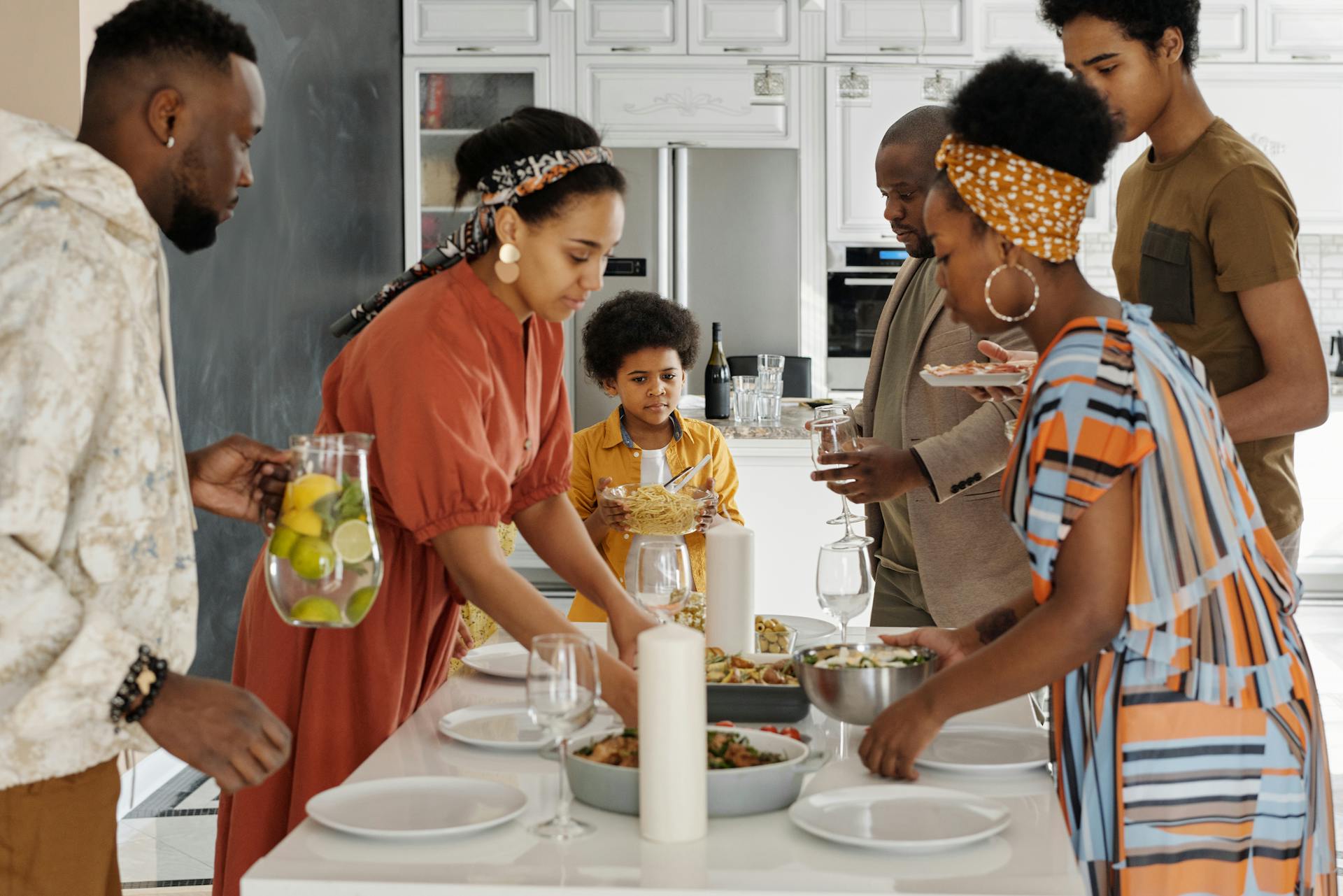 A joyful family gathering around a meal in a warm home setting.