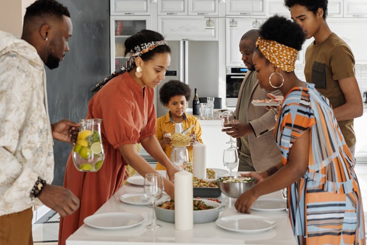 Family Setting The Table For Dinner