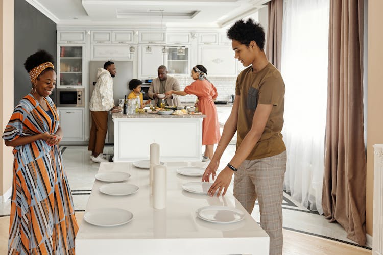 Family Setting The Table For Dinner