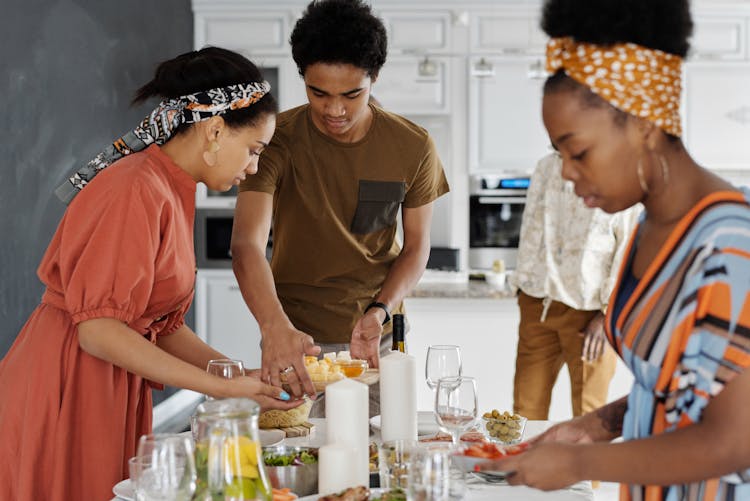 Family Setting The Table For Dinner