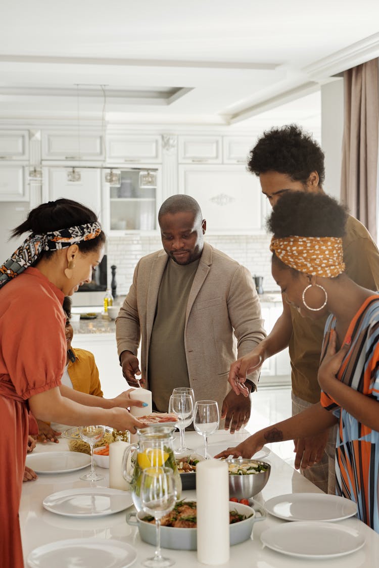 Family Setting The Table For Dinner