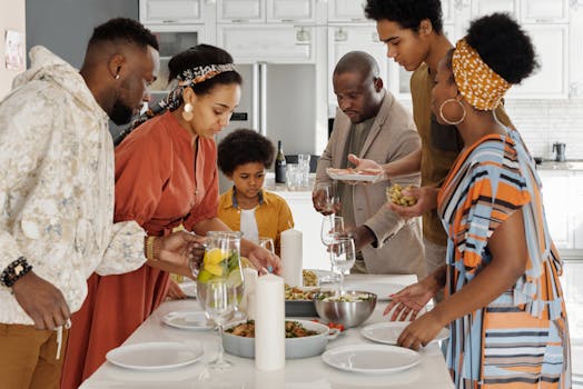 A joyful family gathering around the kitchen table for a meal, fostering togetherness and celebration.