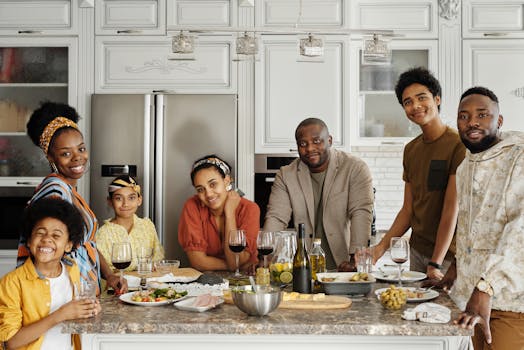 Family enjoying a meal together in a bright kitchen, sharing smiles and laughter.