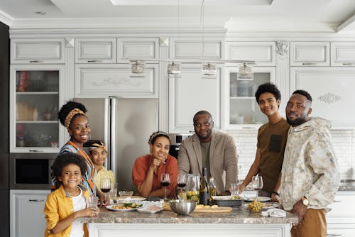 Free Family Posing for a Photo in the Kitchen Stock Photo