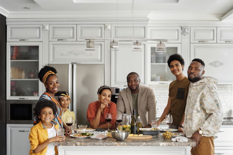 A happy family enjoying a meal together in a modern kitchen setting.