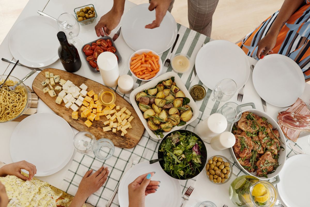 Overhead view of a shared table with several dishes spread out for a group meal