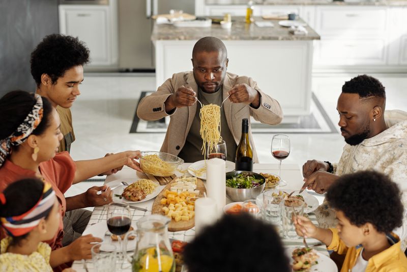 A family passing dishes around a dinner table