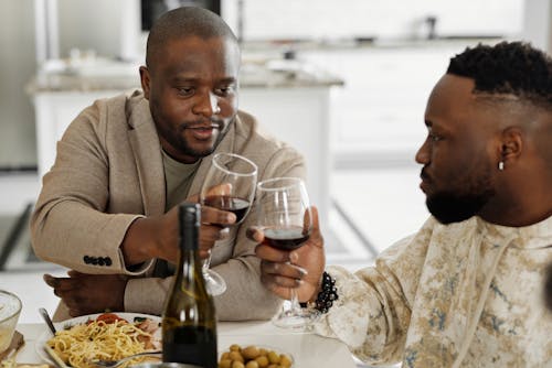 Men Having Dinner and Drinking Wine