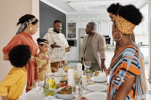 Free A diverse family enjoying a vibrant meal together, showcasing warmth and connection. Stock Photo