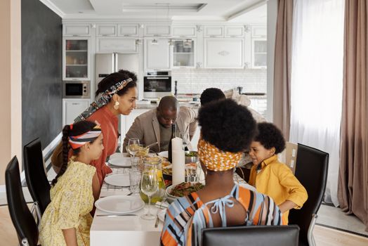 A joyful family enjoying a meal together at home, showcasing love and togetherness.