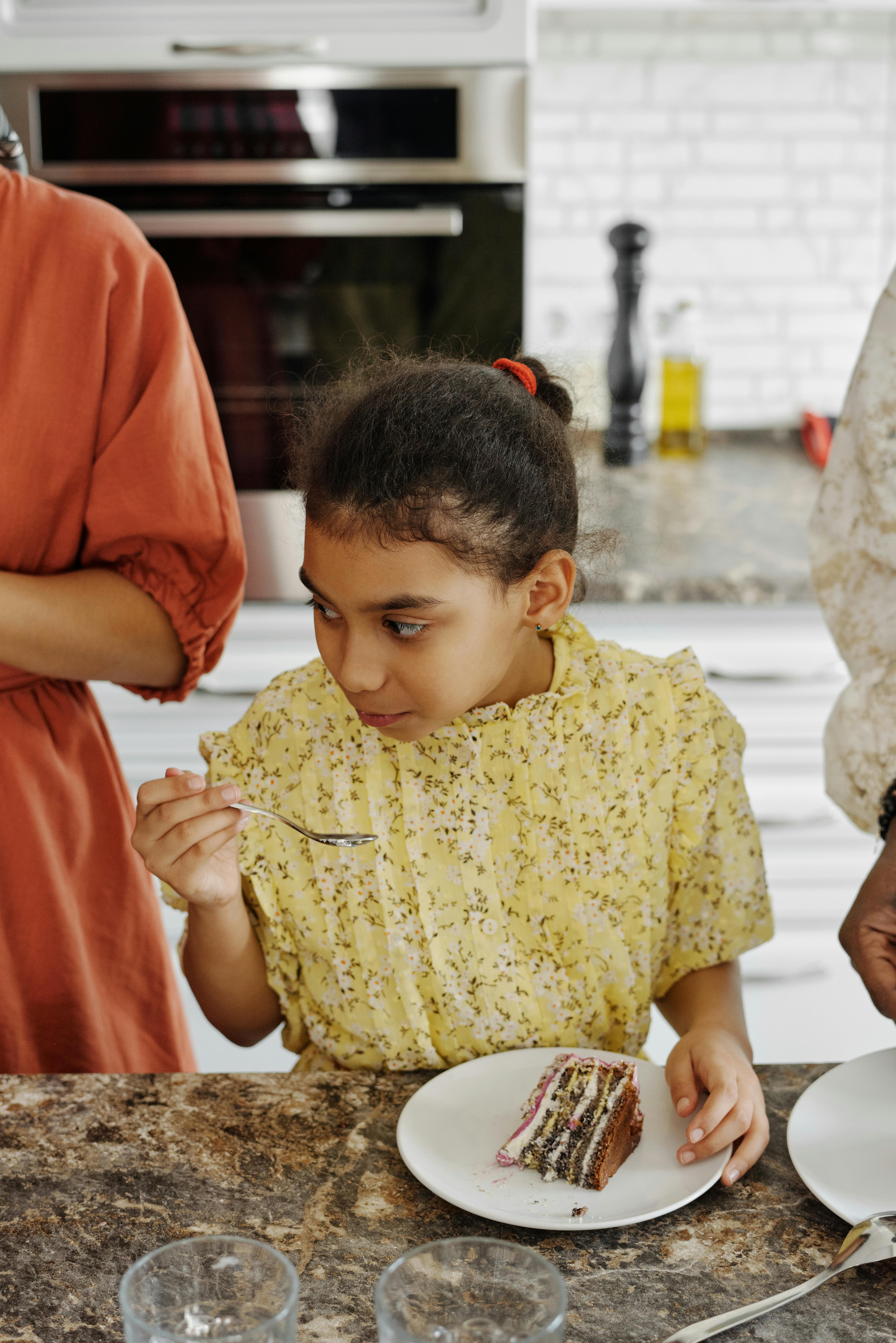 little girl eating cake