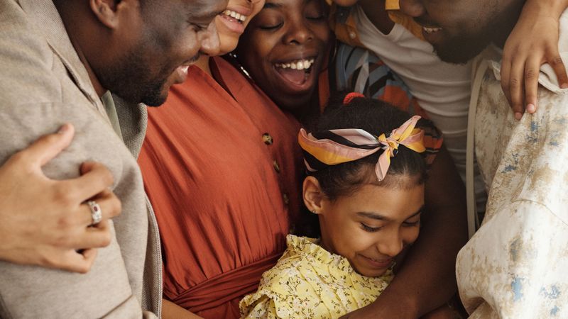 Heartwarming family group hug showcasing affection and togetherness indoors.