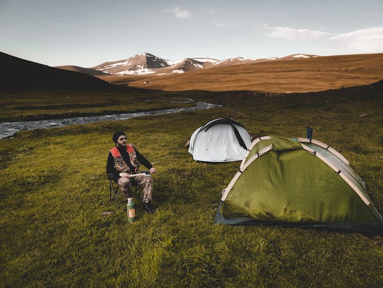 Man Resting On Chair In Campground