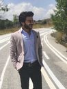 Man in Gray Suit Jacket Standing on Road