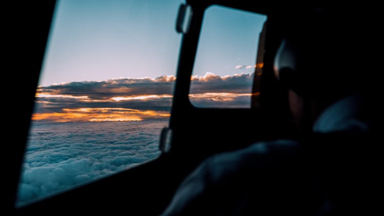 Pilot In Cockpit During Flight In Sky