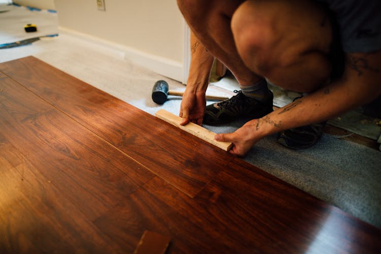 Crop Man Installing Laminate Flooring