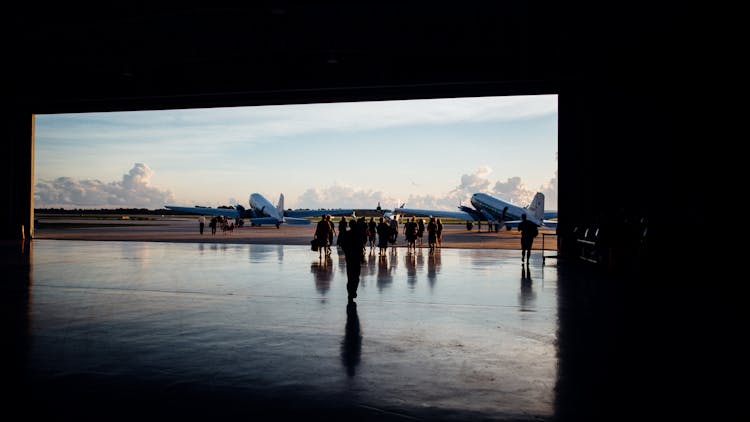 Crowd Of People Walking Towards Airplane