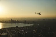 A Helicopter Flying over a Cityscape