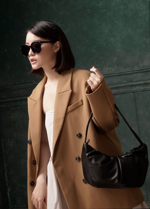 Woman in a Brown Coat Carrying Her Black Handbag
