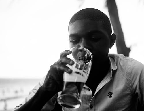 Monochrome Photo of a Man Drinking Beer
