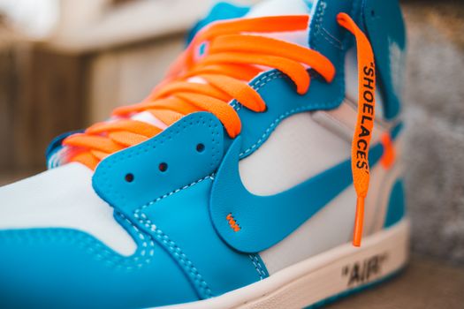 Colorful sneaker with bright laces on step