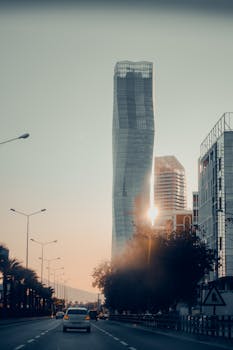 A striking view of a modern skyscraper in İzmir, Turkey, captured at sunset.