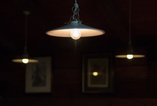 Three Turned-on Pendant Lamps in Room