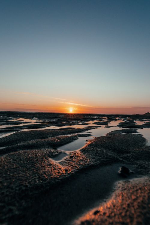 Free Picturesque scenery of calm cloudless sundown sky over wetland with water surface in evening Stock Photo