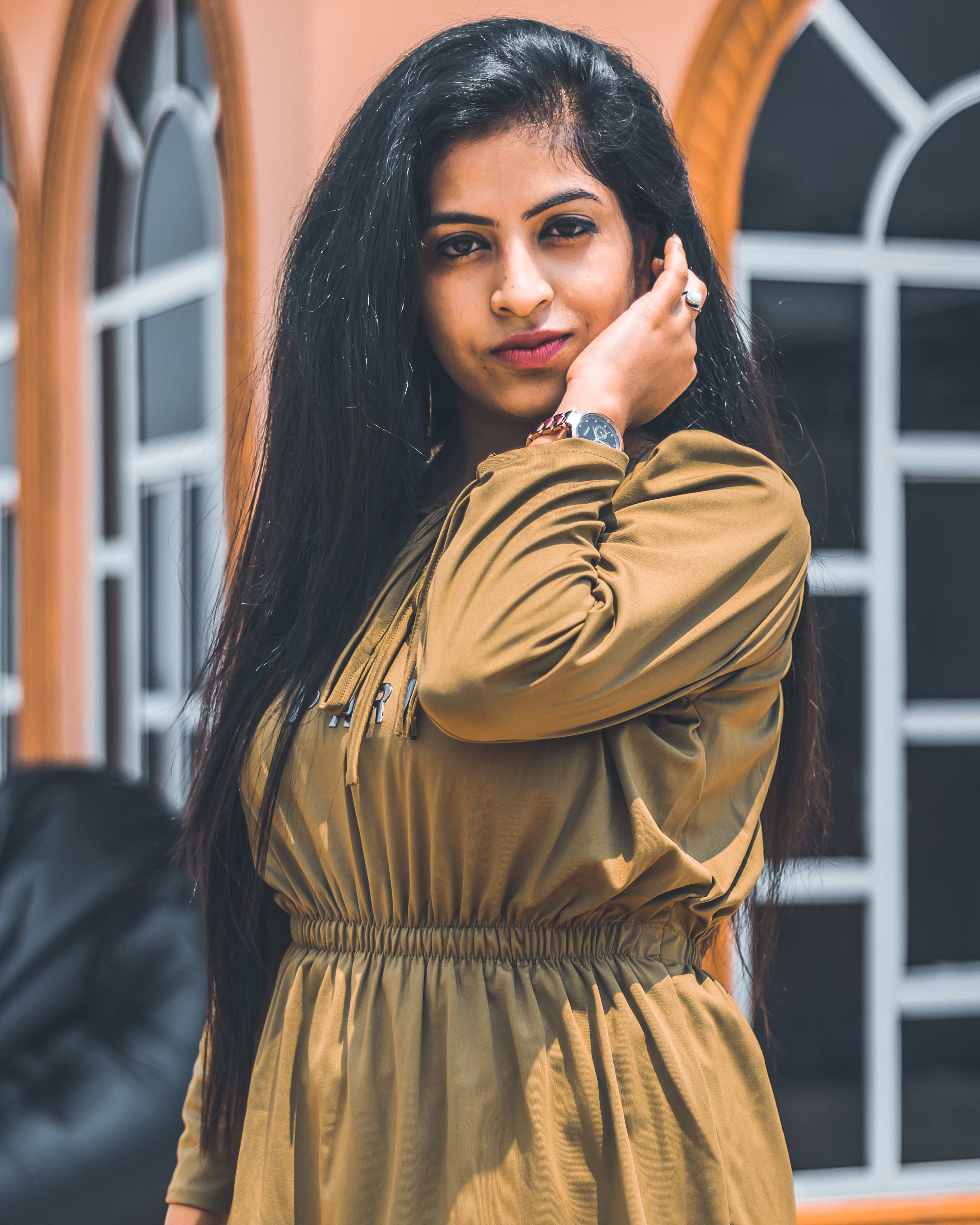 Elegant woman with long hair posing outdoors in Haryana, India, under daylight