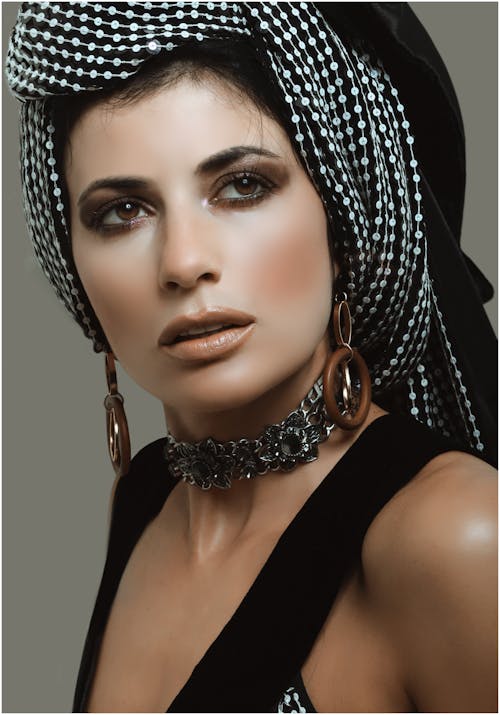 Elegant female model in trendy turban in studio