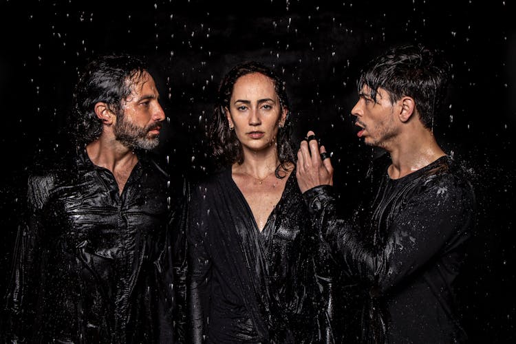 Group Of Artistic People Under Water Drops In Studio