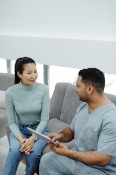 A doctor and patient engaging in a consultation indoors, focusing on health and communication.