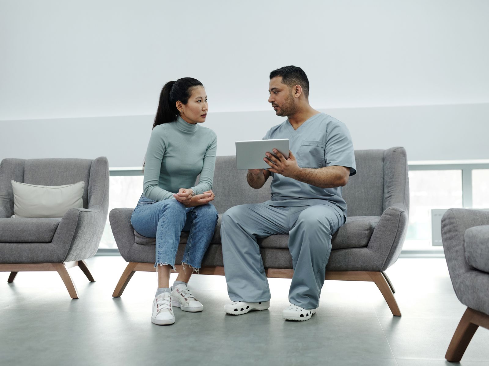 Healthcare professional using a laptop or tablet in a modern practice office