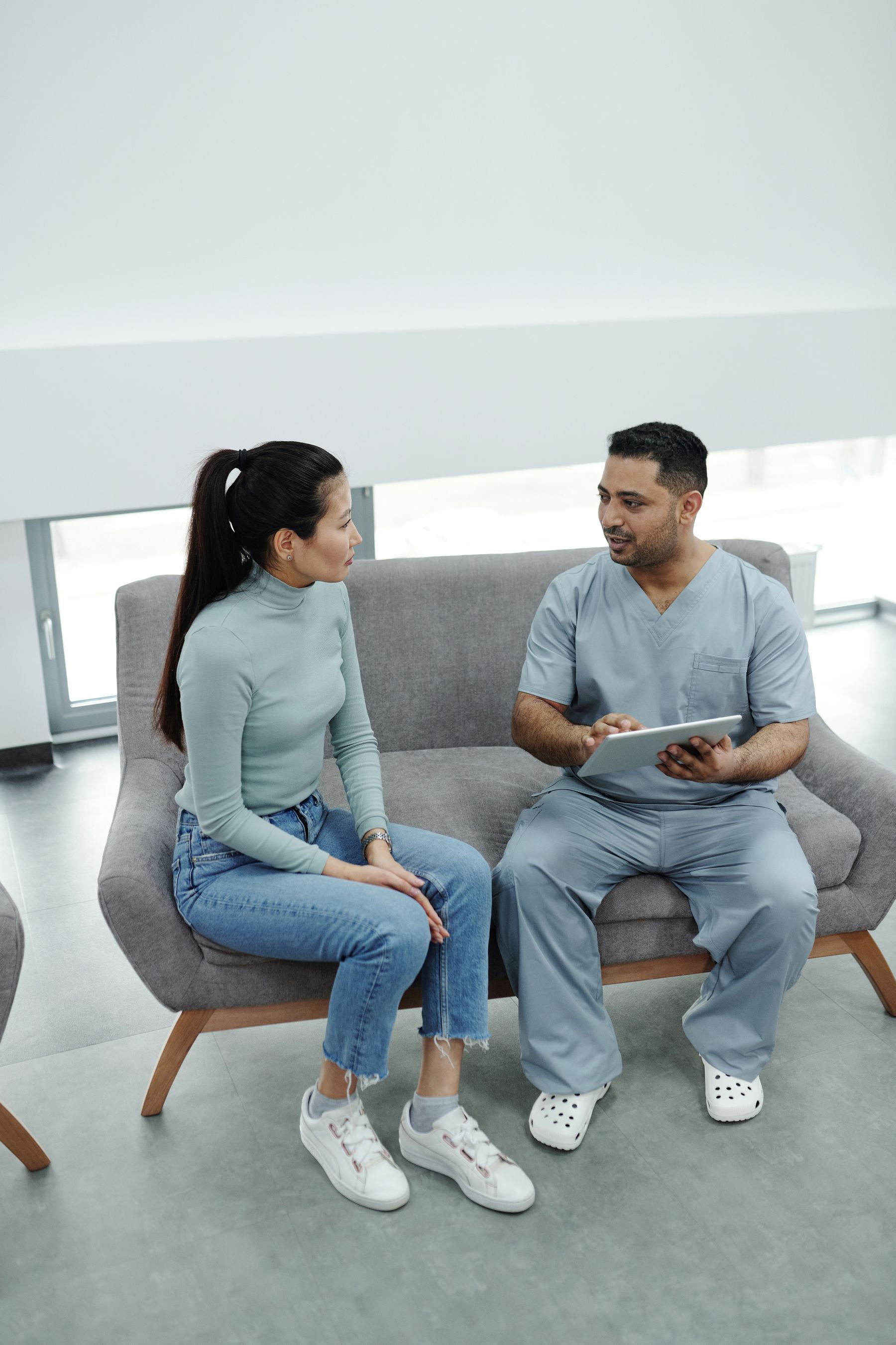 Doctor consulting a patient with a tablet
