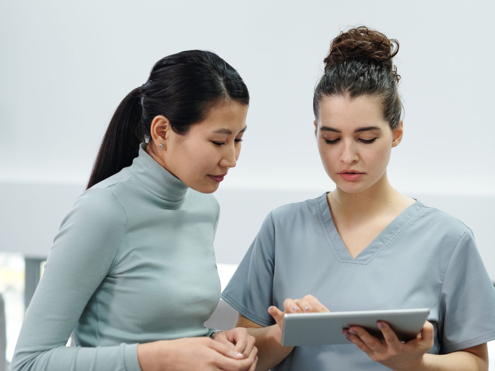 Healthcare professional using a laptop or tablet in a modern practice office