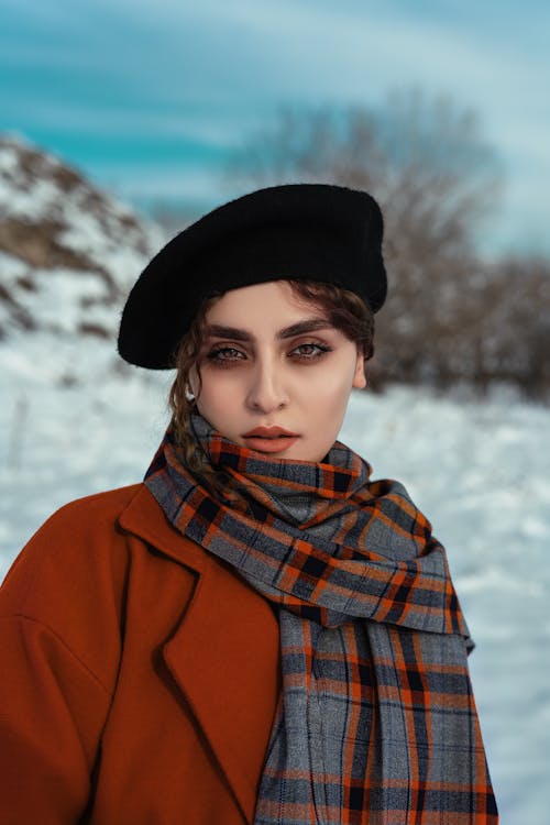 Photo of a Beautiful Woman Wearing a Black Beret and a Gray Scarf