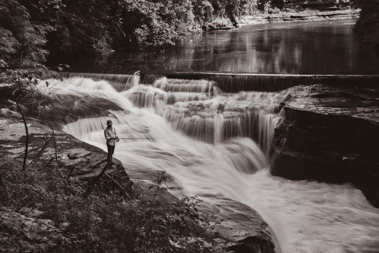 Man Fishing In Rapid Mountain River