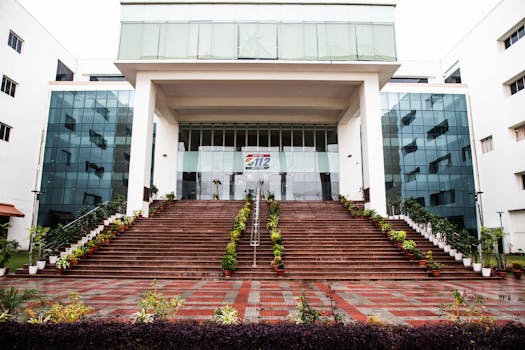 Elegant facade of a government building in Lucknow, Uttar Pradesh with prominent staircase and glass windows.
