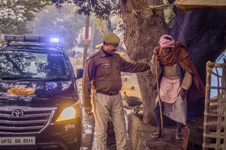 A Policeman Helping An Elderly Woman