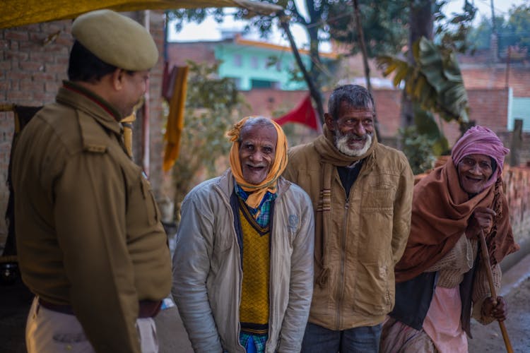 Happy Elderly Men Talking To A Policeman