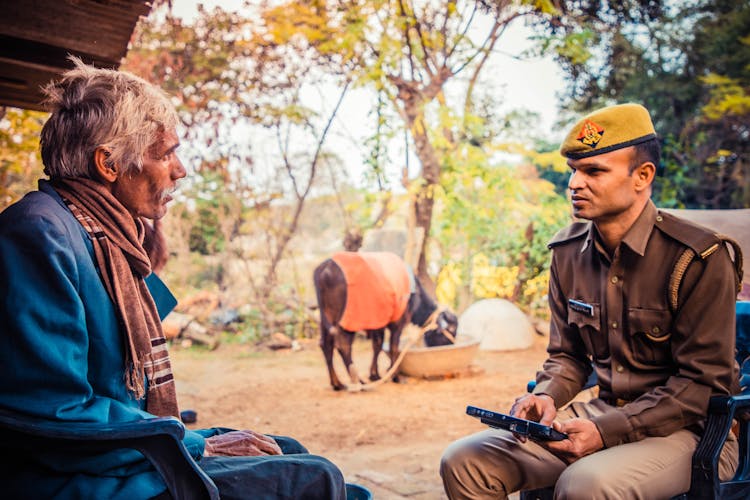 A Policeman Talking To An Elderly Man