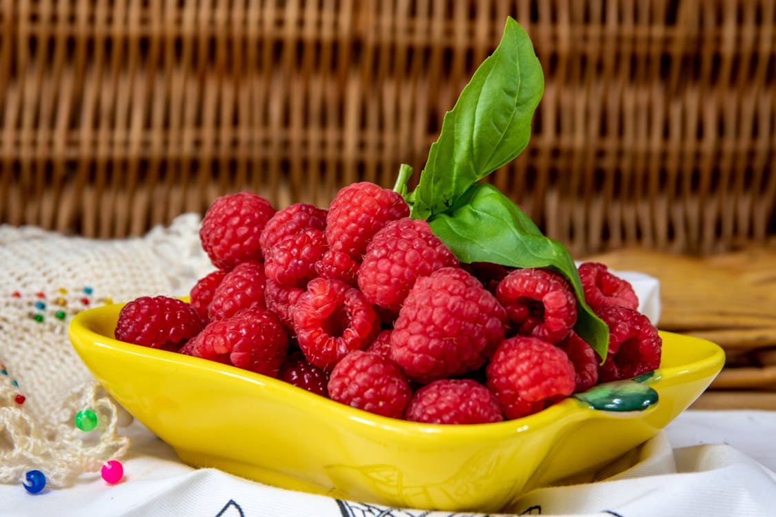 Close-Up Photo of Fresh Raspberries in a Yellow Plate