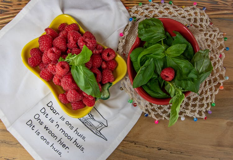 Overhead Shot Of Raspberries And A Bowl Of Basil Leaves