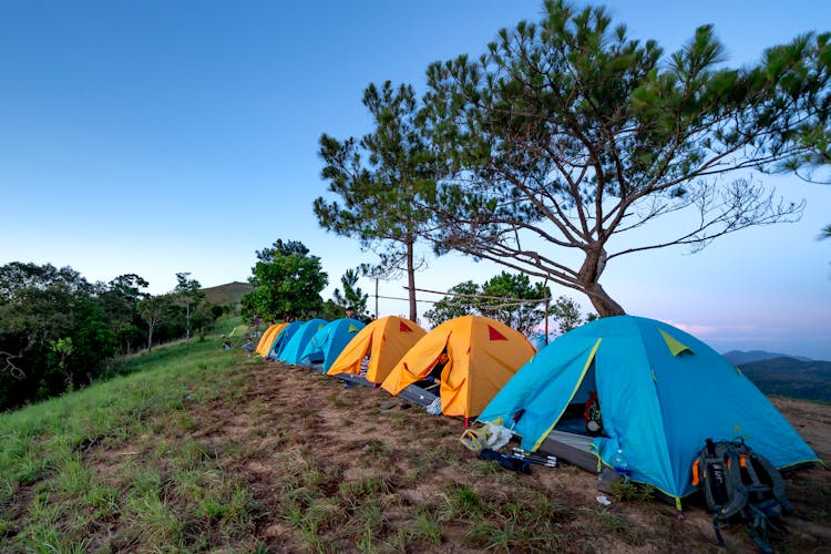 Tents At Campground In Countryside During Sunset