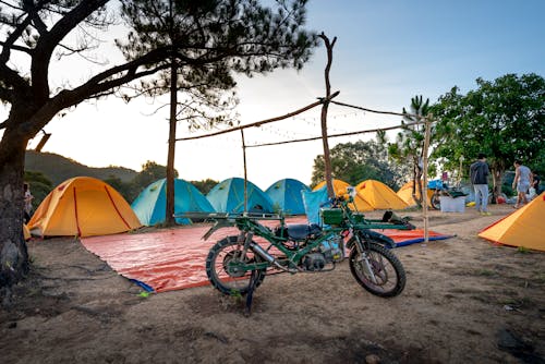 Free Tents and motorbike in camp in nature Stock Photo