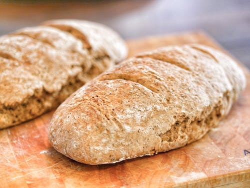 Free Fresh bread loafs on table in bakery Stock Photo