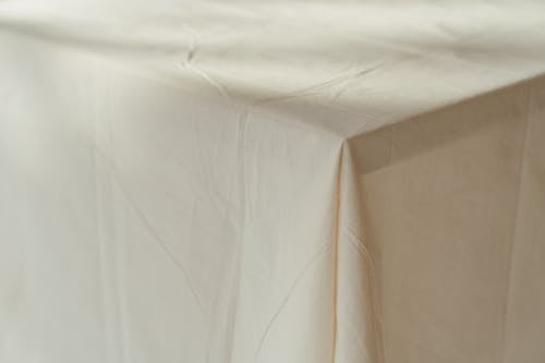 White Textile on Brown Wooden Table